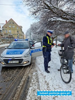 policjant daje odblask rowerzyście